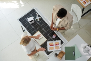 Manager Explaining Buy and Lease Options on Solar Panels in Maryland